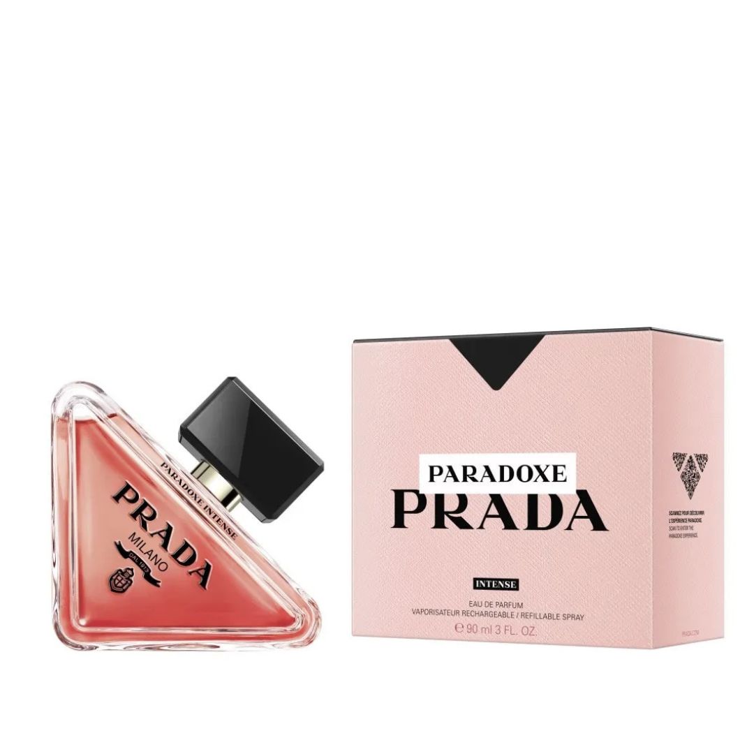 A luxurious bottle of Prada Paradoxe Intense Eau De Parfum, featuring a deep amber color and a sleek, minimalist design.